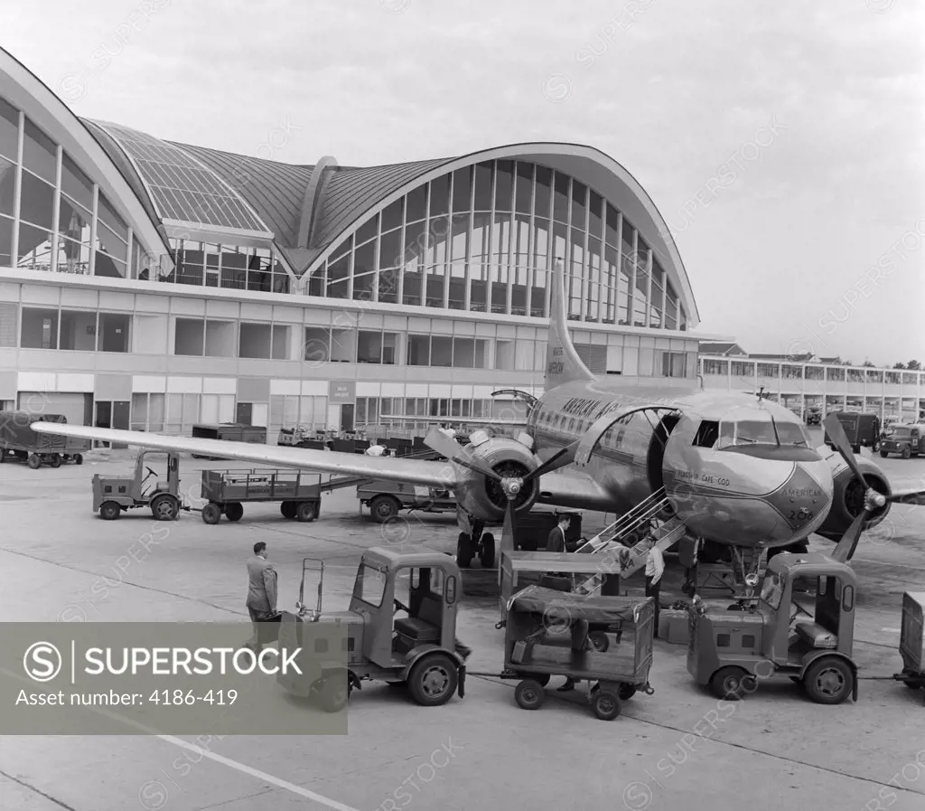 1950S 1960S St. Louis Missouri Airport Propeller Airplane On Tarmac In Front Of Terminal With Modern Arch & Window