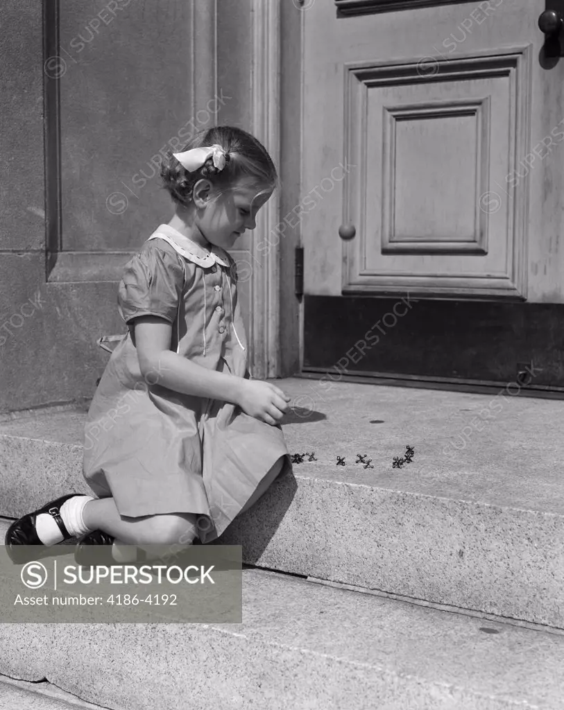 1930S 1940S Child Little Girl Sitting On Stoop Playing Jacks