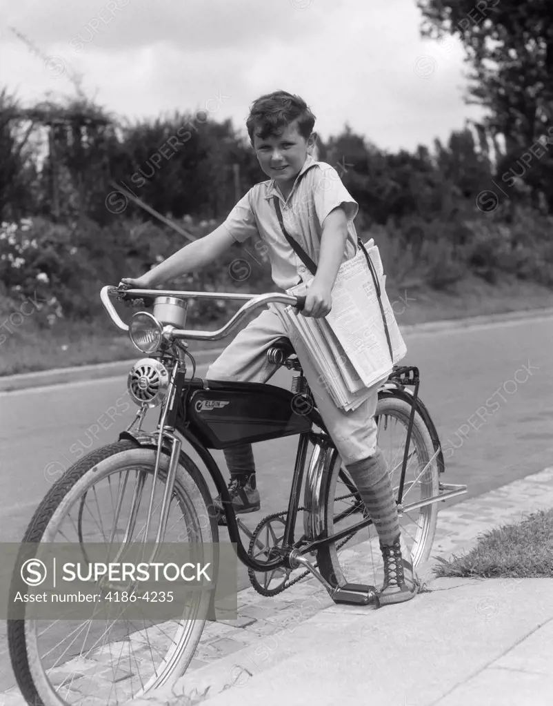 1940S Boy On An Elgin Bike Carrying Newspapers In A Sling Wearing Knee Socks And Sneakers