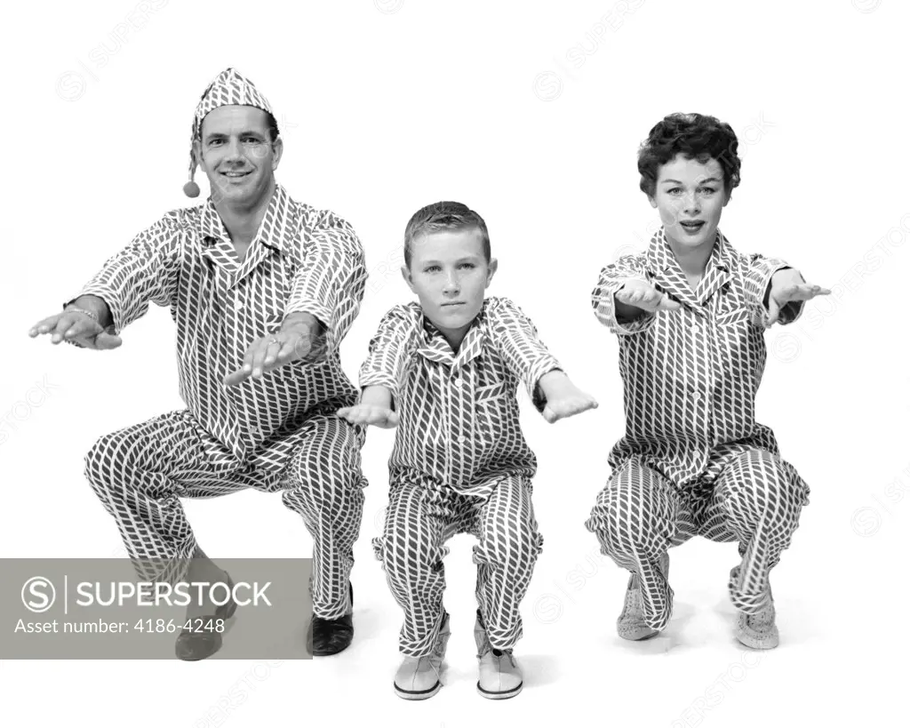 1950S Family Of 3 In Pajamas Doing Knee Bends Facing Camera