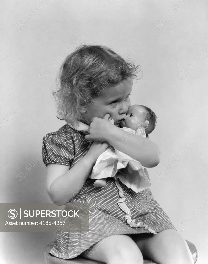 1930S Serious Sad Toddler Girl Kissing Baby Doll