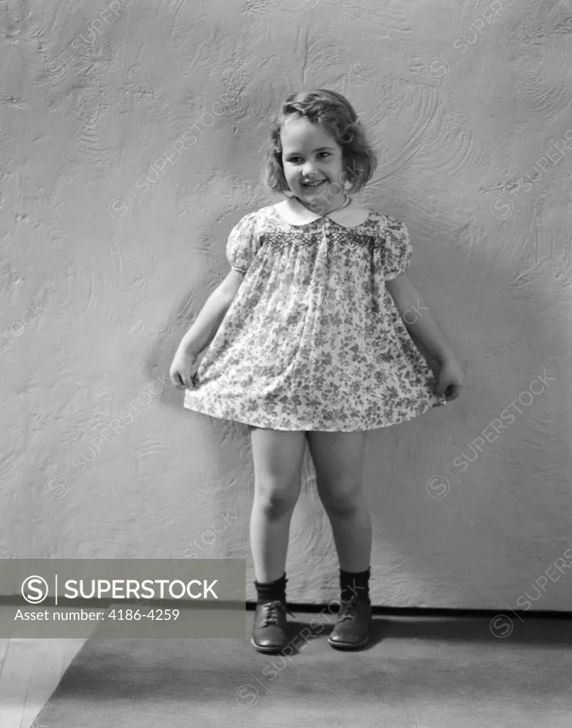 1940S Little Girl Wearing Floral Print Dress Ready To Take A Bow