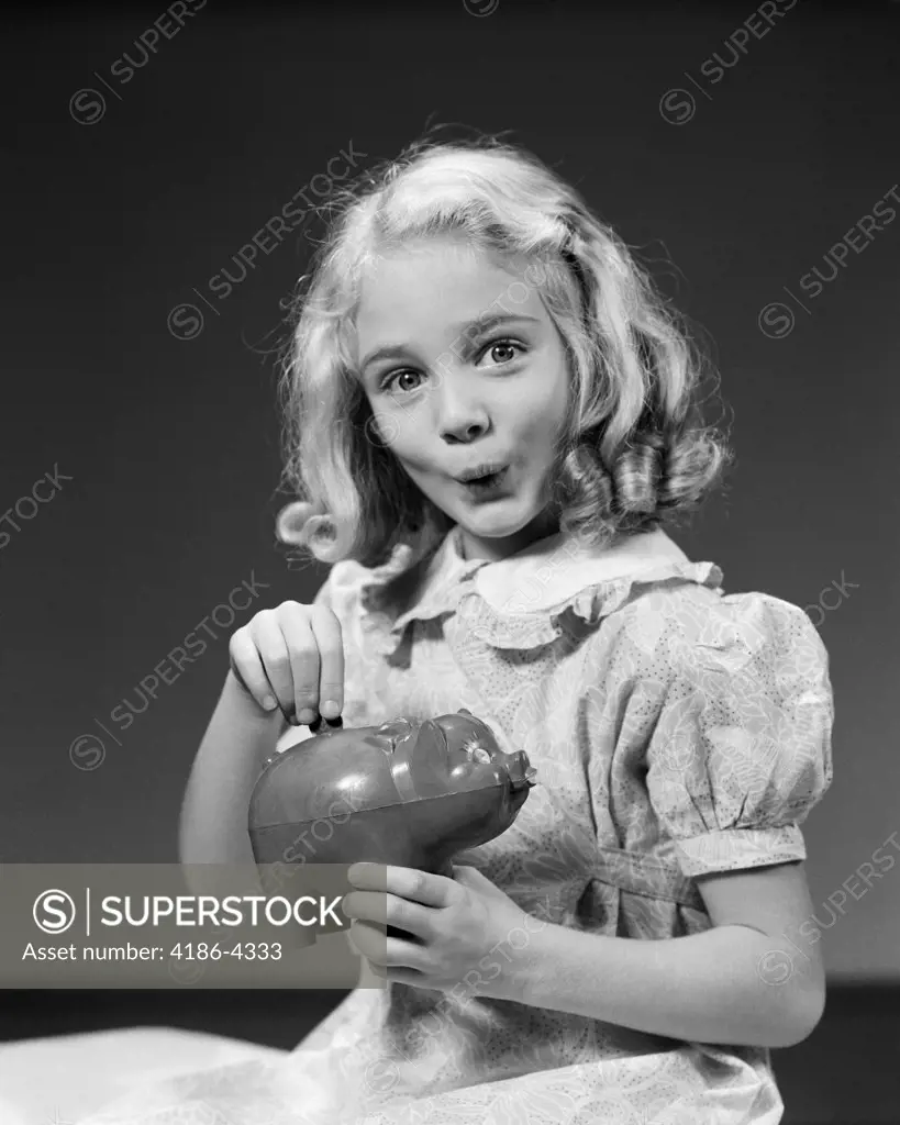 1940S Child Blond Girl Putting Money Coin Into Piggy Bank