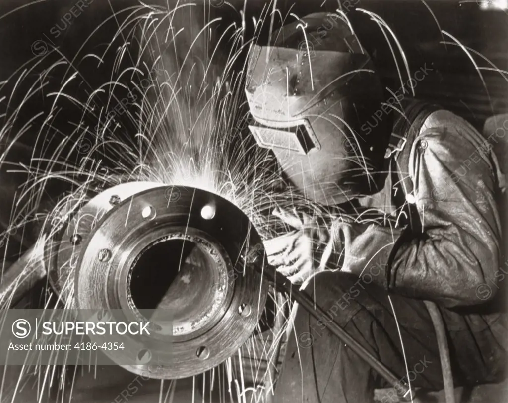 1950S Man Industrial Welder Welding Pipe Wearing Protective Mask