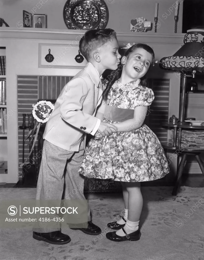 J1950S Little Boy In Suit And Tie Trying To Kiss Little Girl In Party Dress