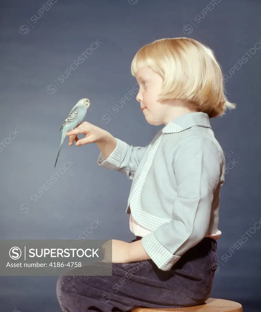 1950S 1960S Blond Girl With Pet Bird Parakeet On Her Finger    
