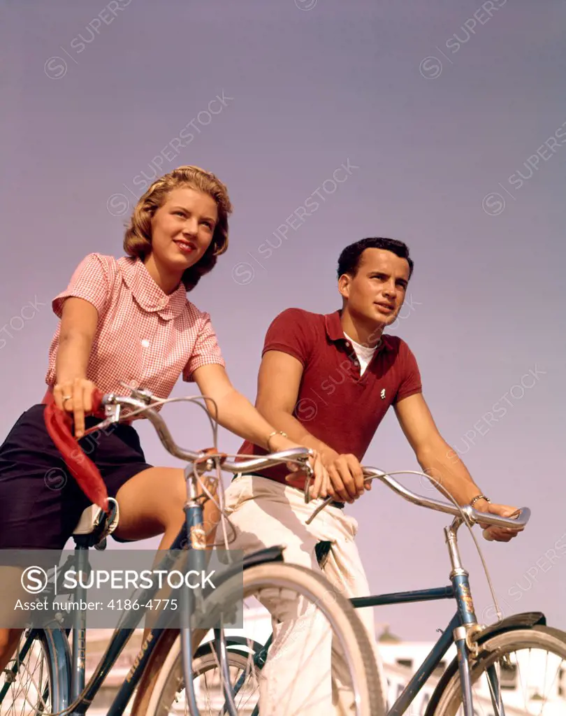 1950S 1960S Couple Man Woman Riding Bicycles Outdoors