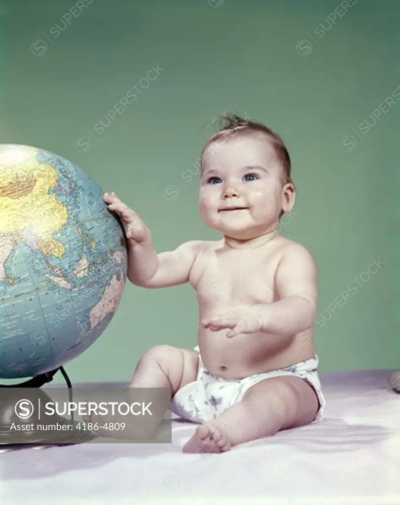 1960S Smiling Baby Girl Sitting In Diapers Hand Touching World Globe