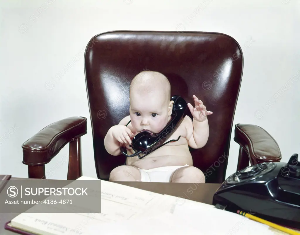 1960S Chubby Baby Sitting Leather Chair At Office Desk Holding Telephone