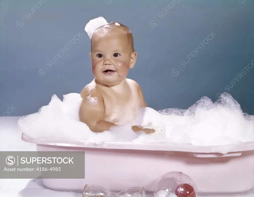 1960S Smiling Baby Sitting In Bathtub Bubble Bath Covered With Soap Bubbles