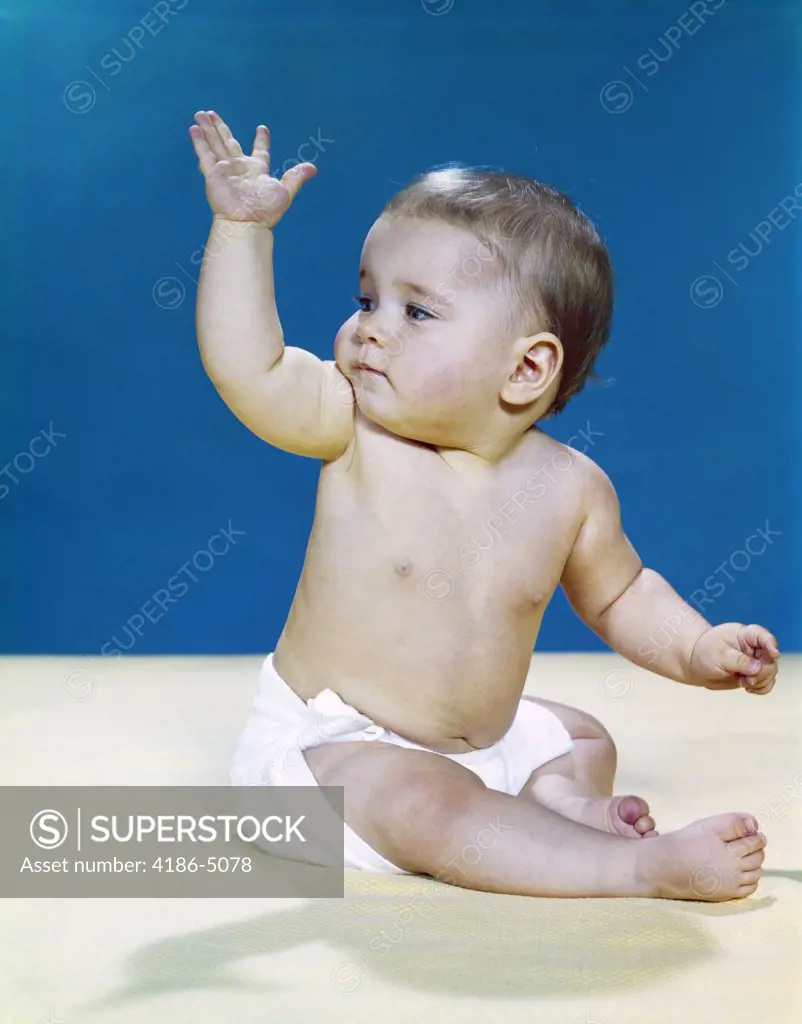 1960S Baby Wearing Cloth Diaper Looking Over Shoulder Waving With Raised Arm Gesture