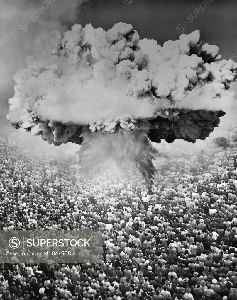 1950S 1960S Atomic Bomb Symbolic Montage Mushroom Cloud Over A Very Large Crowd Of People Facing The Explosion