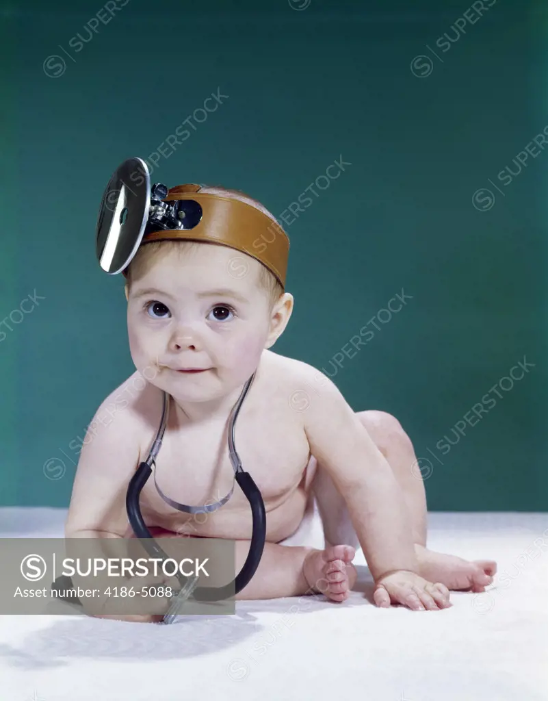 1960S Baby Making Funny Face Wearing Medical Doctor Opthalmoscope And Stethoscope