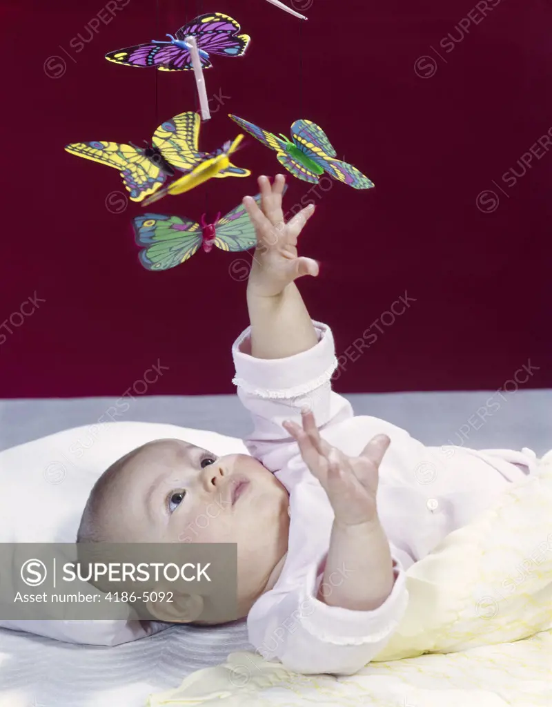 1960S Baby Reaching Up To Grab Mobile Of Butterflies