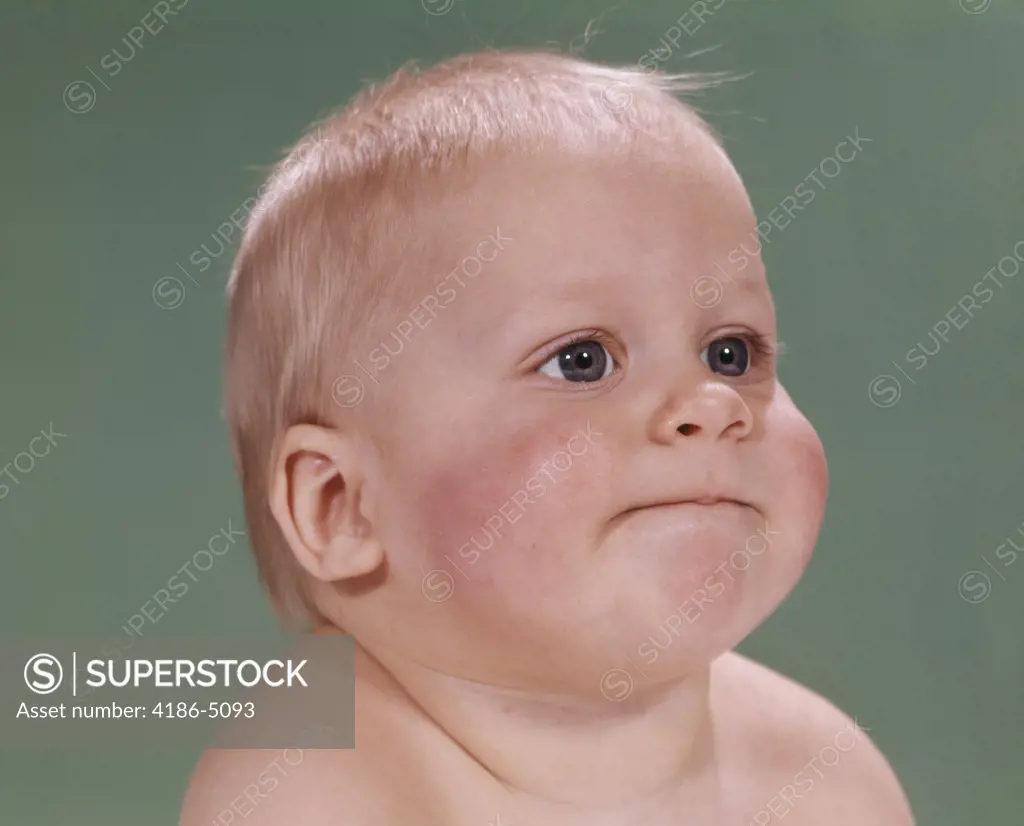 1960S Portrait Of Blond Baby Chubby Cheeks With Funny Face Expression