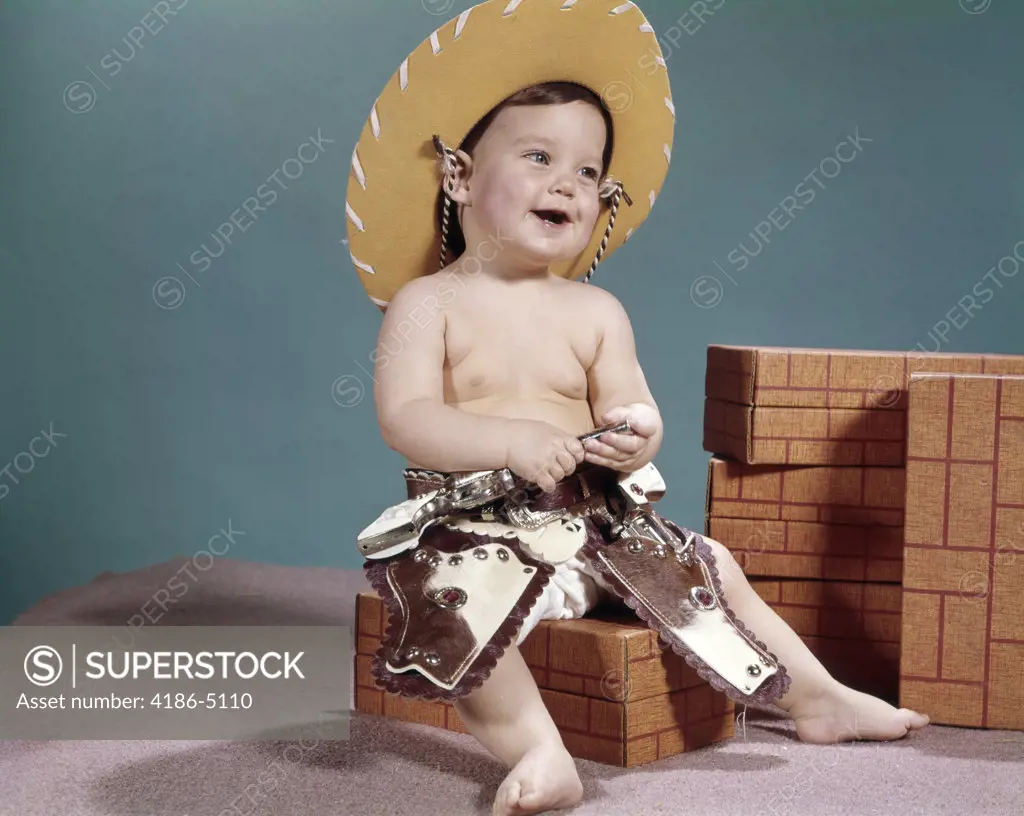 1960S Smiling Baby Wearing Cowboy Hat And Cap Pistols And Western Holsters