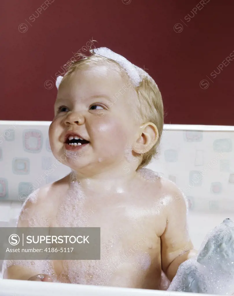 1960S Smiling Happy Baby In Bathtub Covered With Soap Suds Bubbles