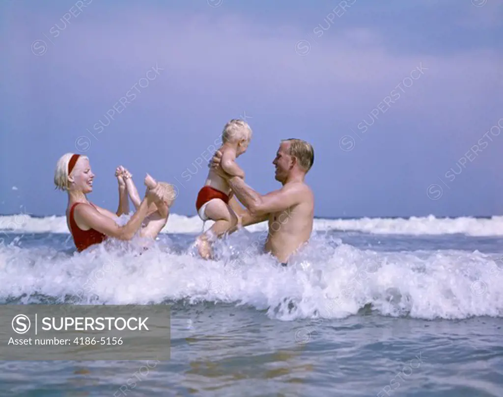 1970S Family Playing In Ocean Surf