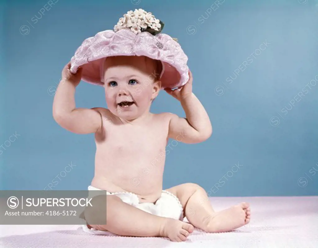 1960S Smiling Baby Girl Wearing Diaper And Large Pink Hat