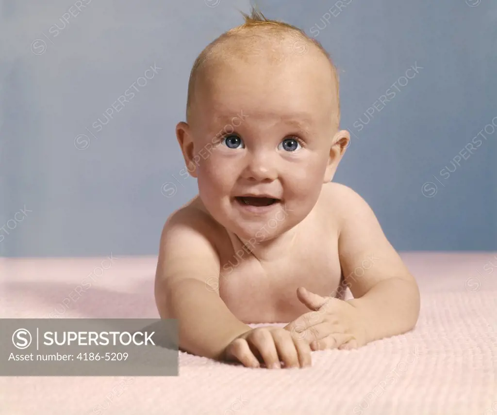 1970S Smiling Happy Baby Crawling Straight Ahead On Pink Blanket Looking At Camera