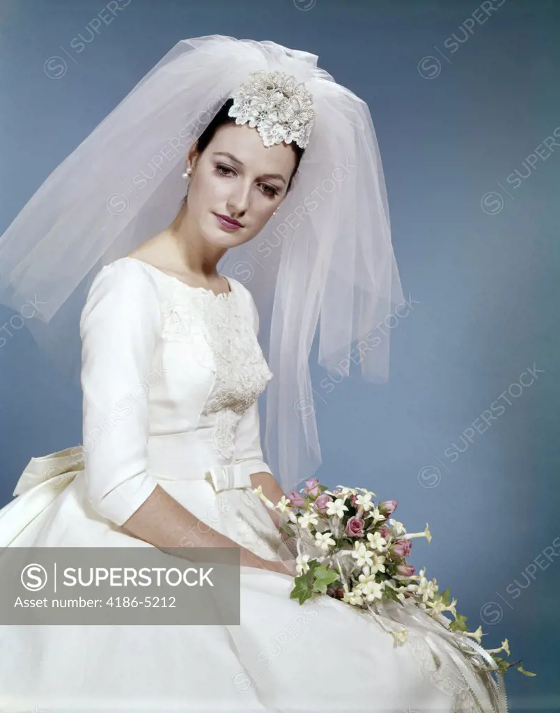 1960S Formal Portrait Of Bride Sitting Holding Flower Bouquet