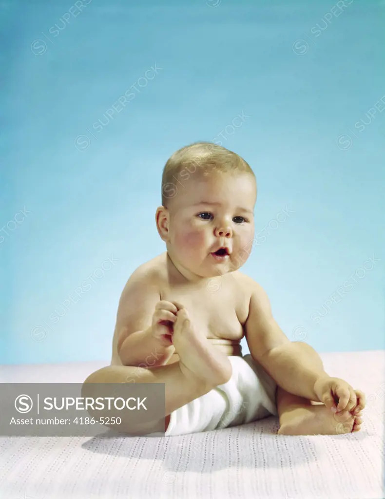 1960S Baby Sitting Holding On To His Feet