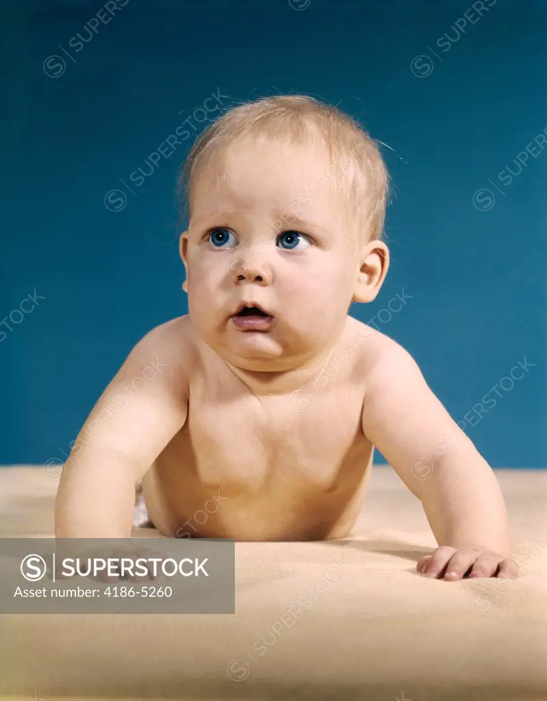 1960S Baby Big Blue Eyes Raised Up On Arms Looking To Side