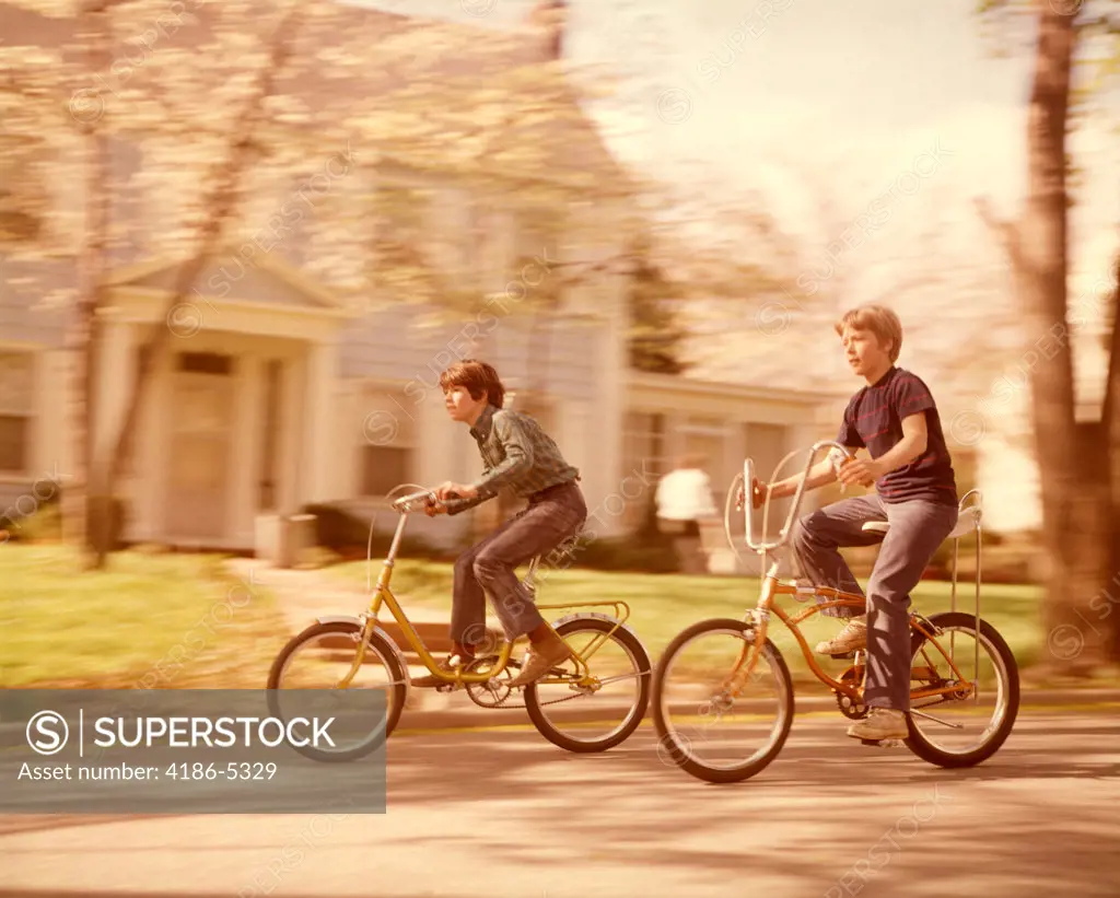 1970S Boys Riding Bikes  On Suburban Street Springtime