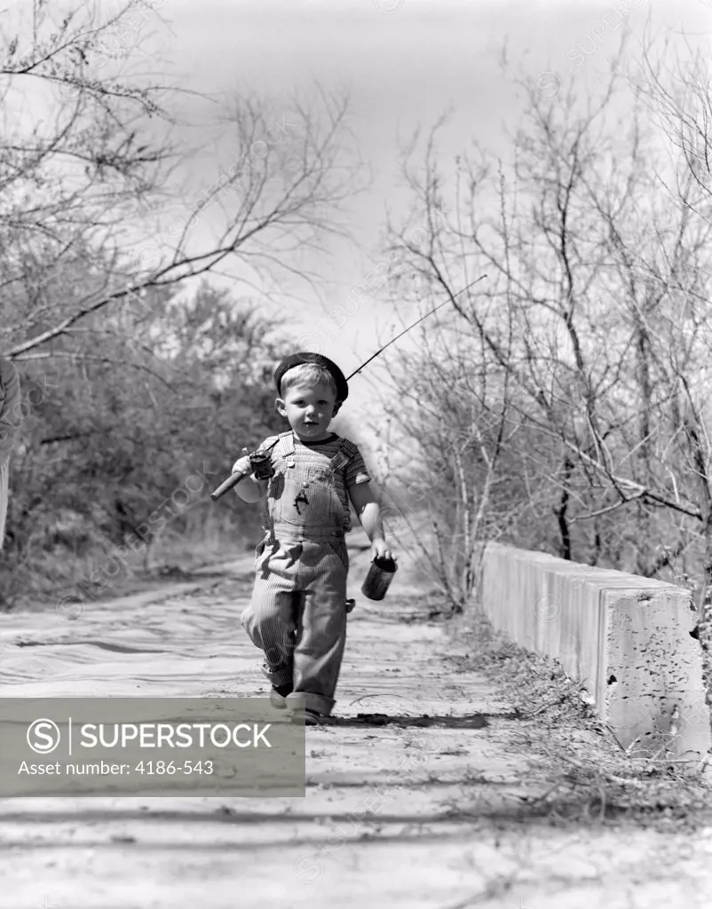 1940S Boy Walking Down Country Road With Can Of Worms And Fishing Pole