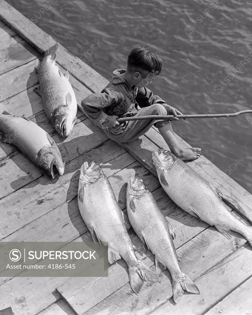 1930S Boy Seated On Dock With 5 Large Fish Fishing With Stick Pole