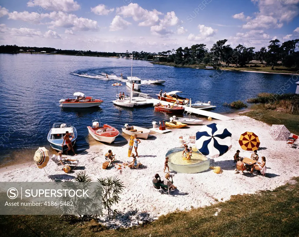 1960S People On Small Sandy Beach Umbrellas Boats Summer Fun Vacation Florida Cypress Gardens