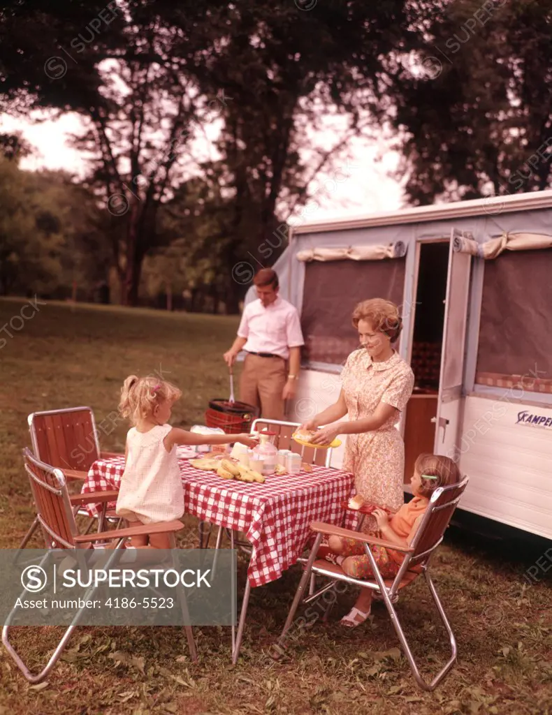 1960S Family Rv Camping Father Grilling Mother  And Girls Setting Table 
