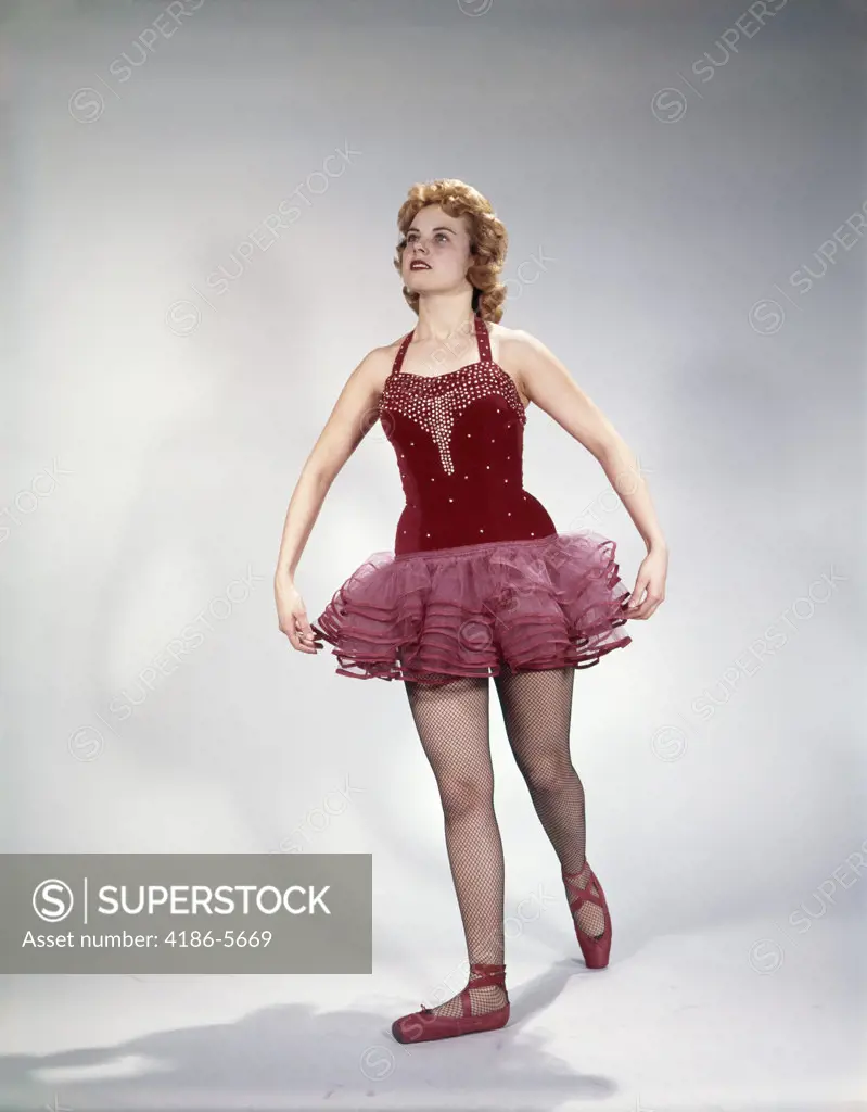 1960S Awkward Teenage Girl Dancer In Red Velvet Tutu Costume And Toe Shoes