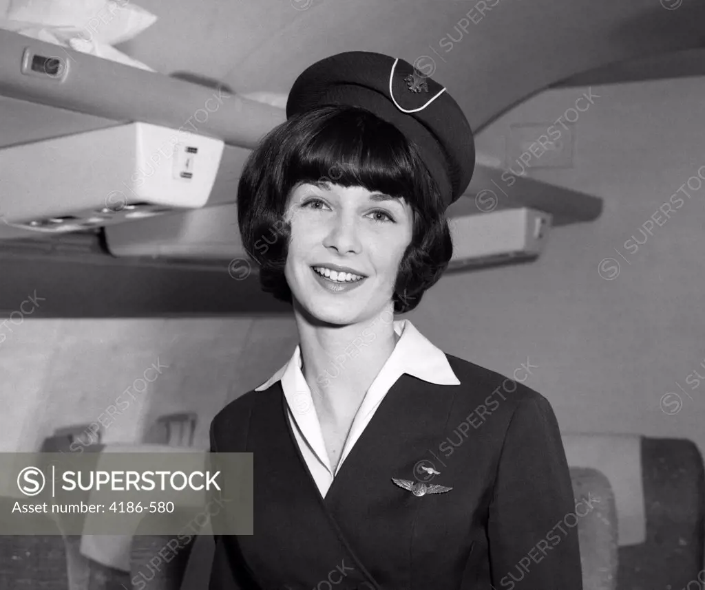 1960S Smiling Portrait Of Airline Stewardess In Airplane Aisle
