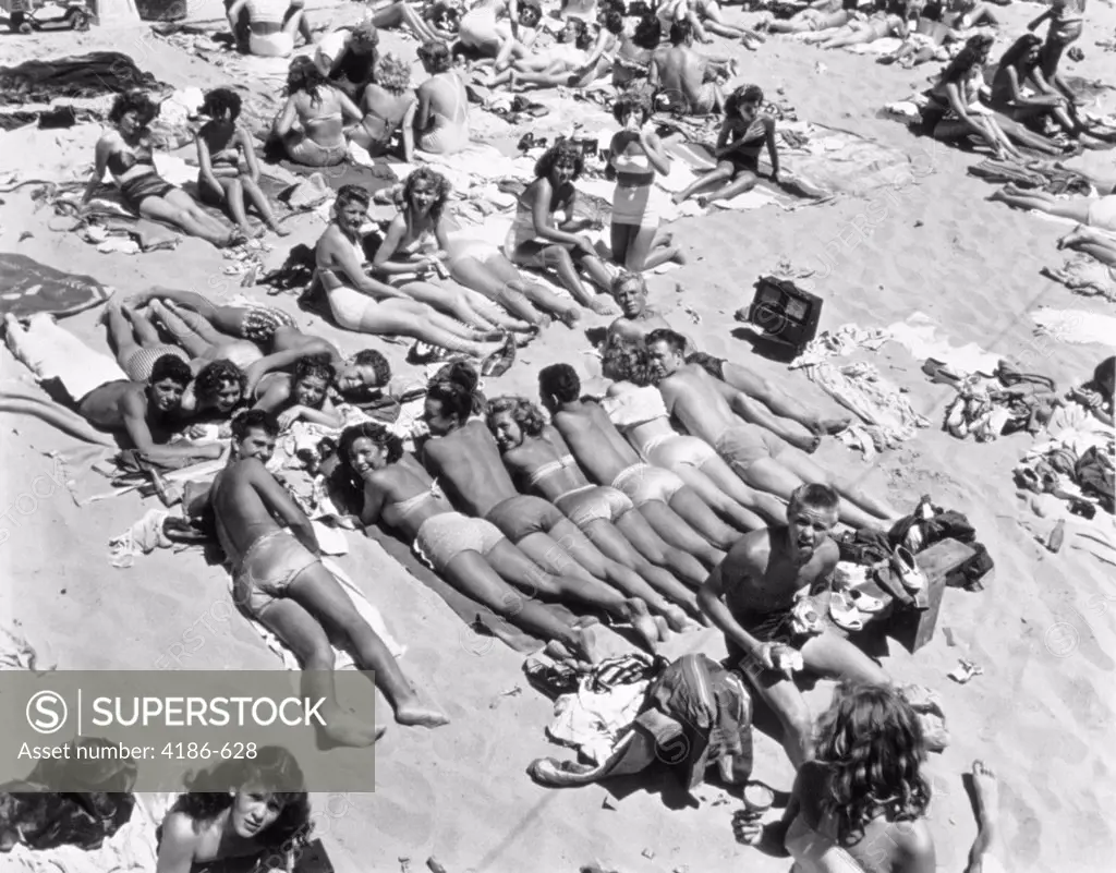 1950S Hermosa Beach Los Angeles County California Group Sunbathing Teenagers Looking Up At Camera