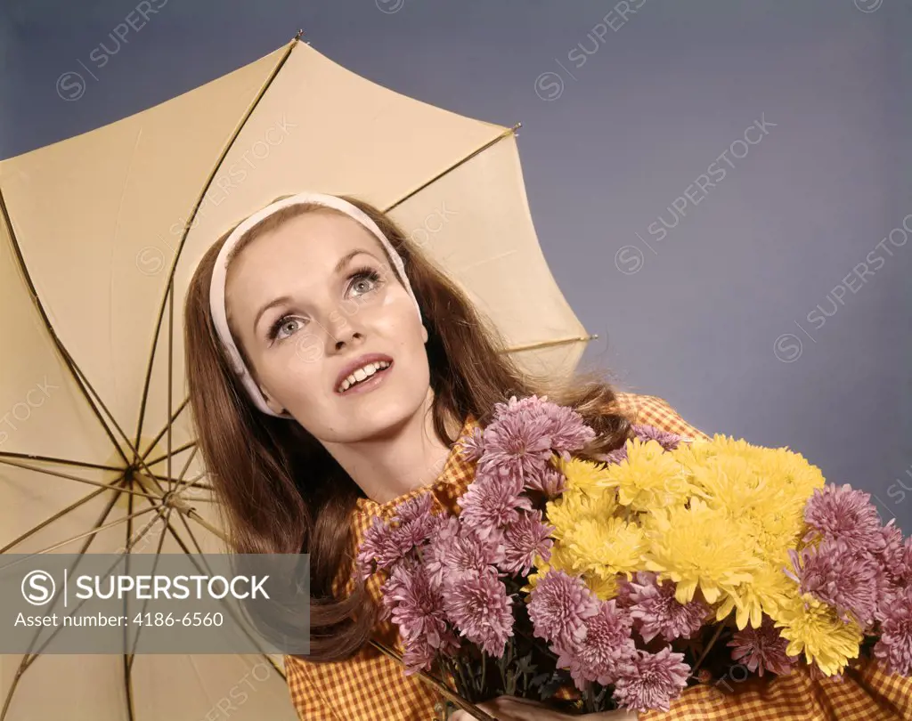 1960S Woman Red Hair Holding Bunch Of Flowers Under Umbrella