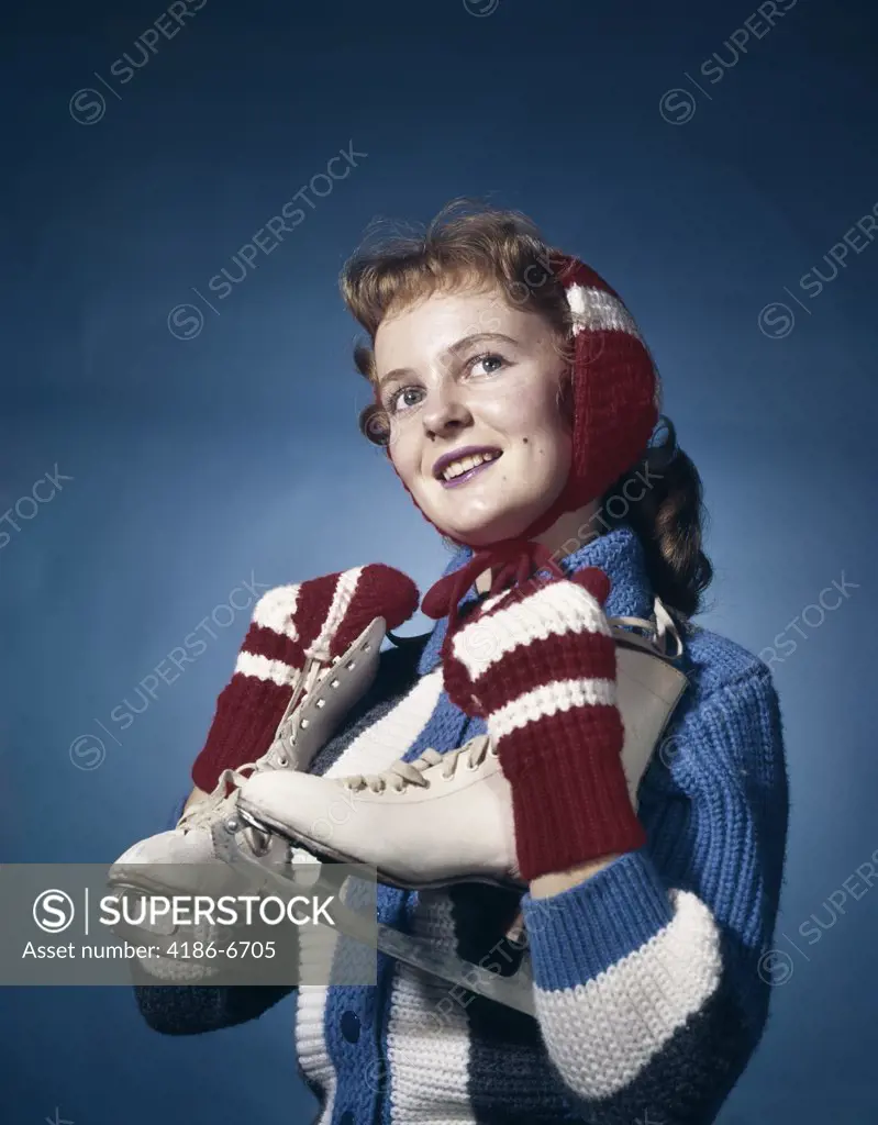 1960S Smiling Woman Wearing Red Mittens Ear Muff Blue Sweater Holding Ice Skates  