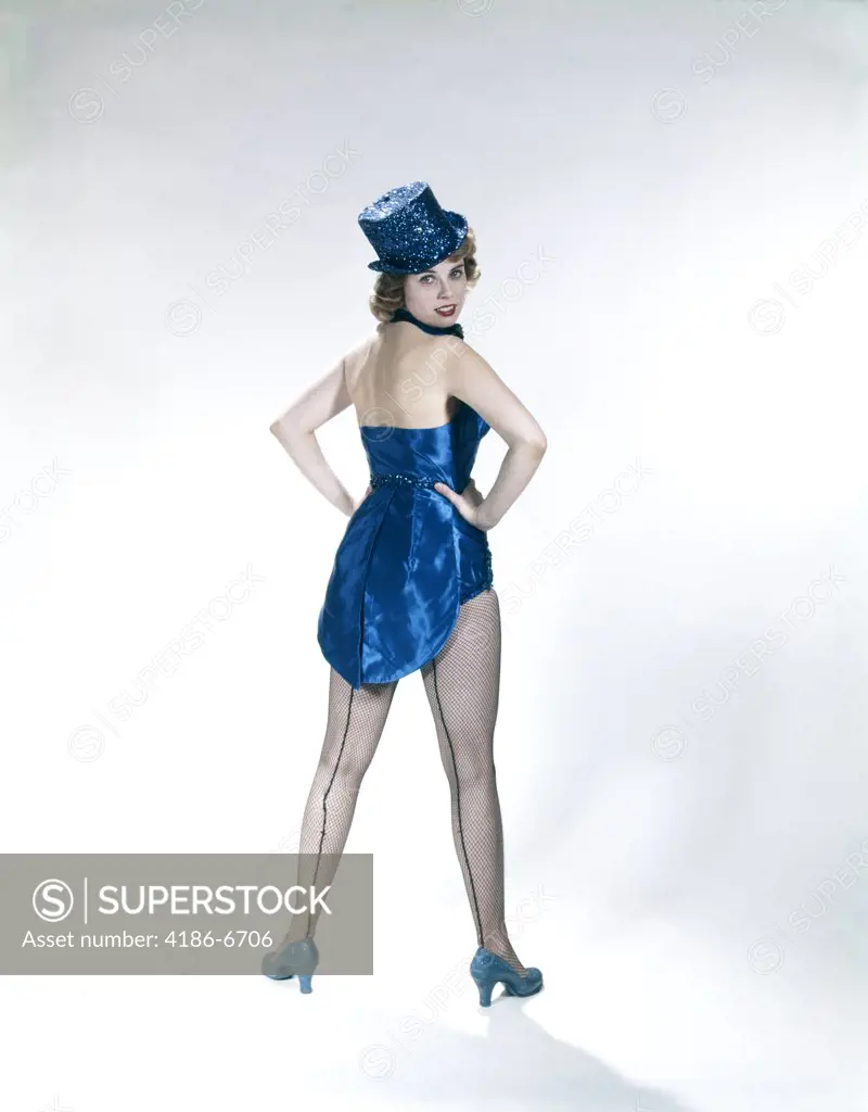 1960S Woman Looking Over Shoulder Wear Dance Costume Blue Sequined Top Hat Silk Tails Fishnet Seamed Stockings