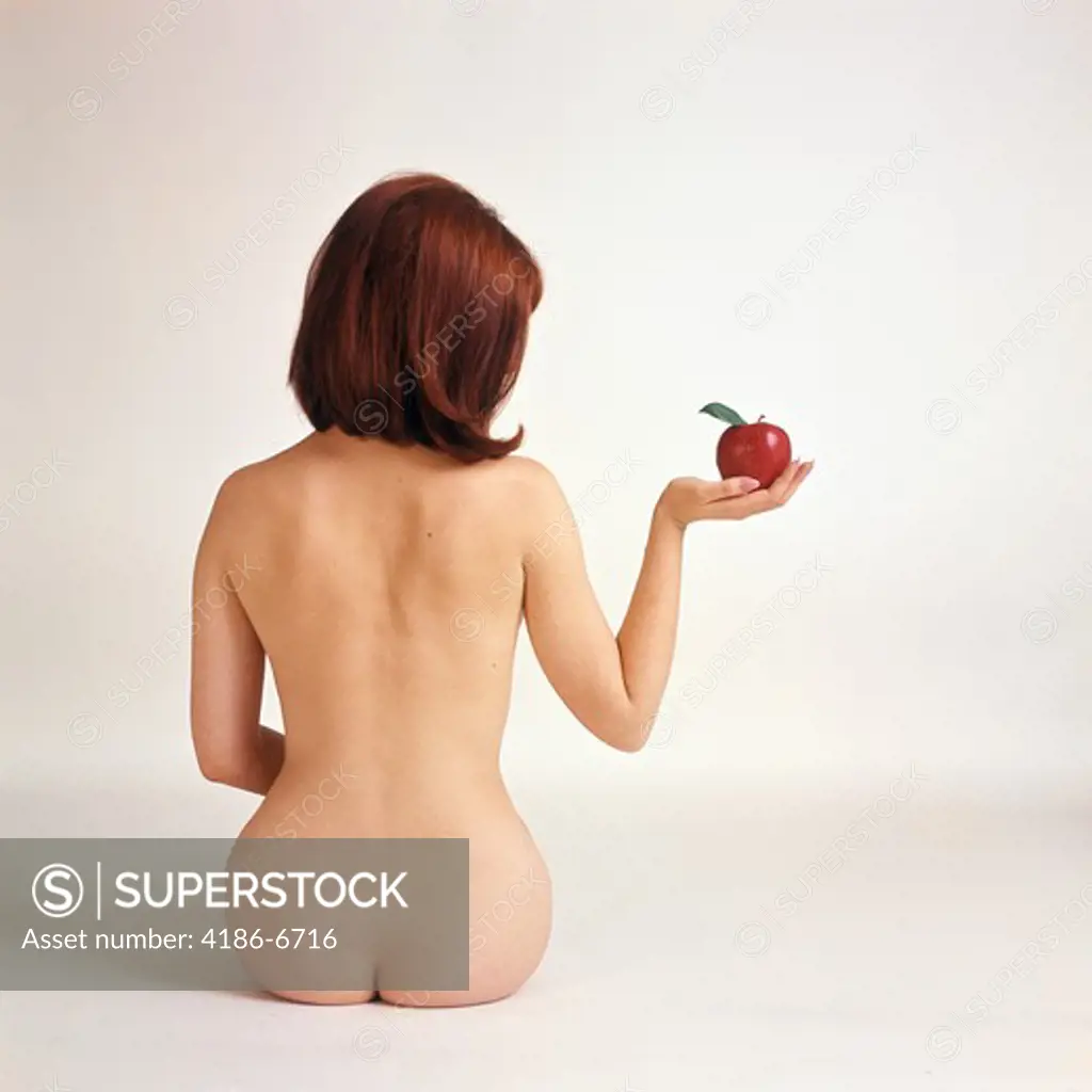 1960S 1970S Back Of Nude Woman Sitting Holding Red Apple