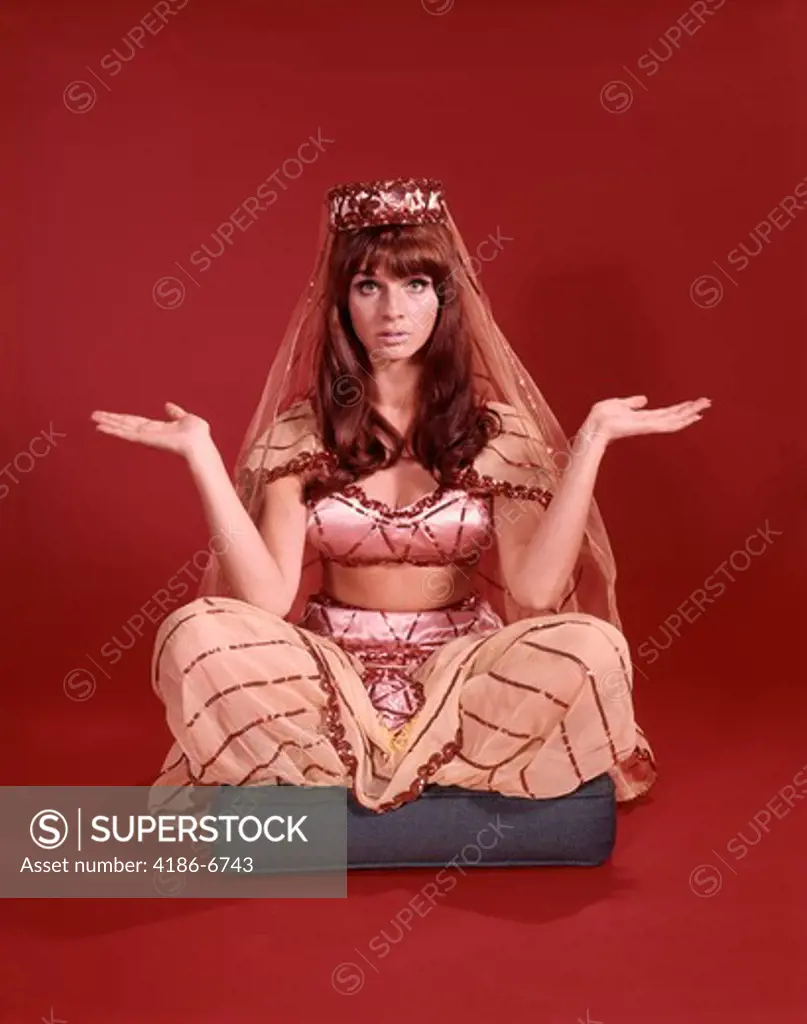 1960S Perplexed Seated Woman Dressed In Harem Dancing Girl Costume