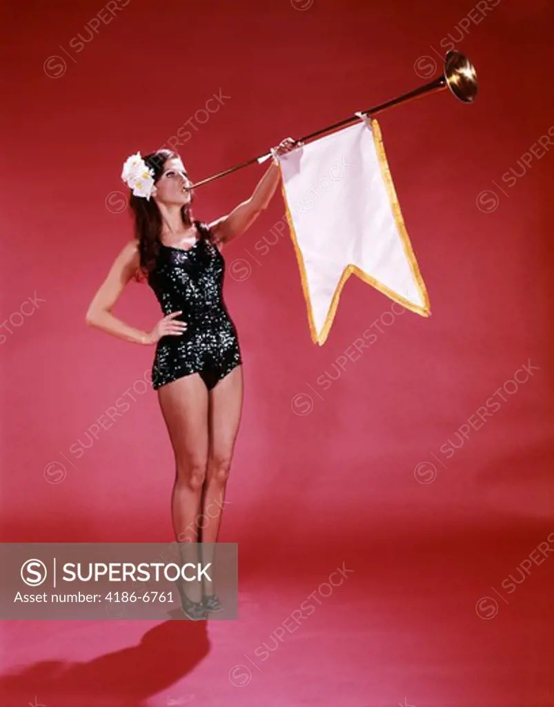 1960S Young Woman In Sequined Black Swimsuit Blowing Baroque Trumpet With Pennant