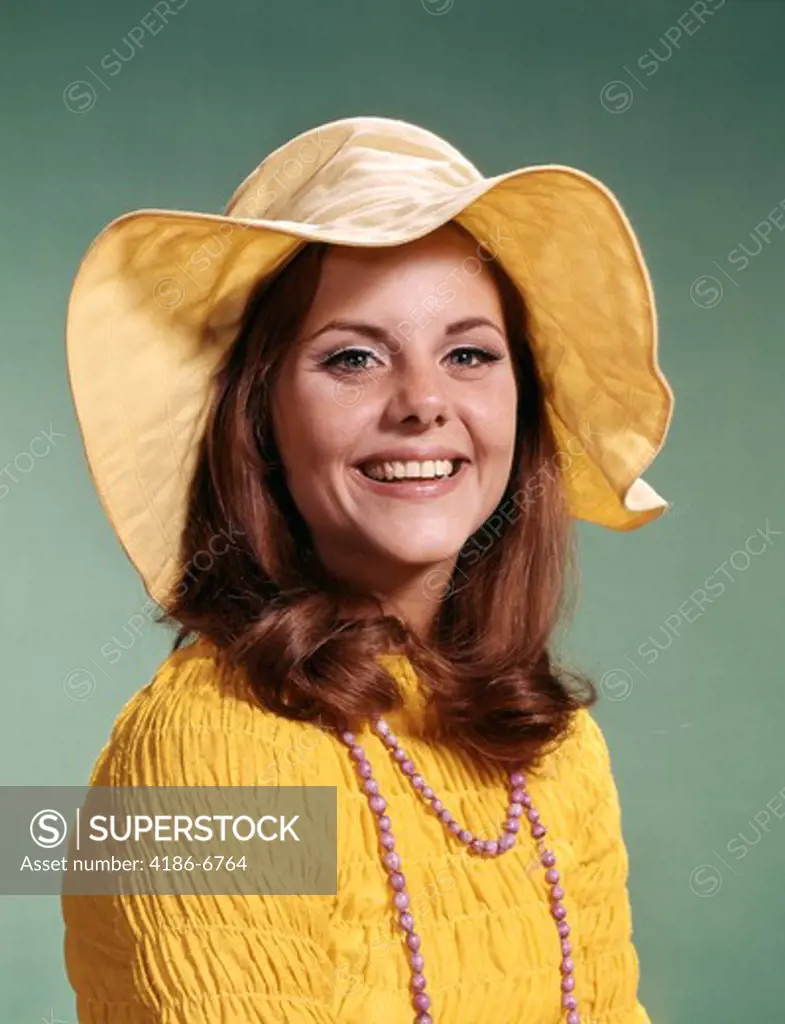 1970S Smiling Young Woman Wearing Yellow Floppy Brim Hat And Blouse With Pink Beads
