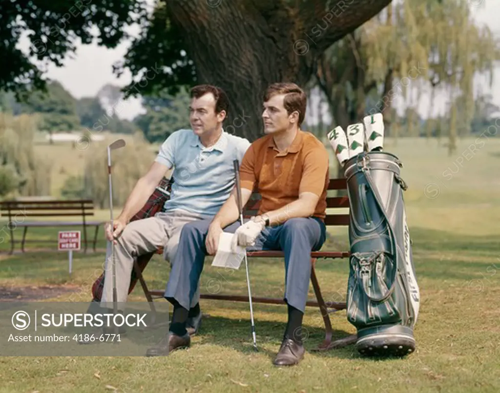 1960S Two Men Sitting Under Tree Waiting To Tee-Off   