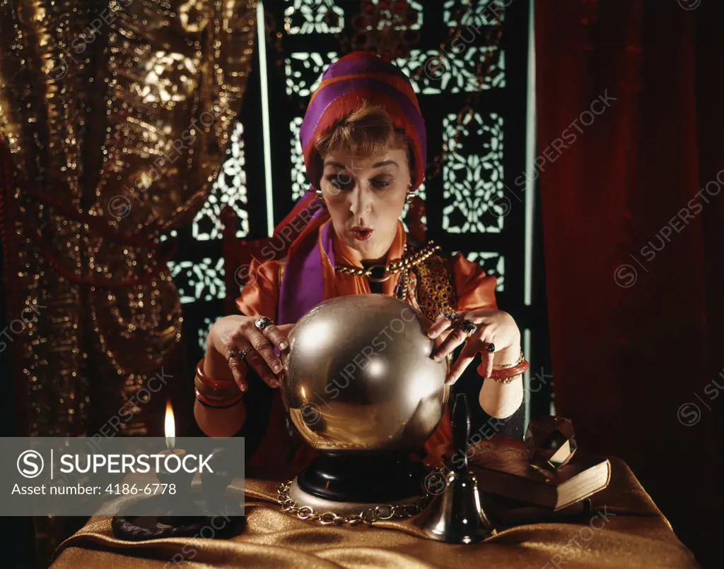 Woman Dressed As Fortune Teller Looking Into Crystal Ball Lace Curtains And Carved Shutter Background Indoor