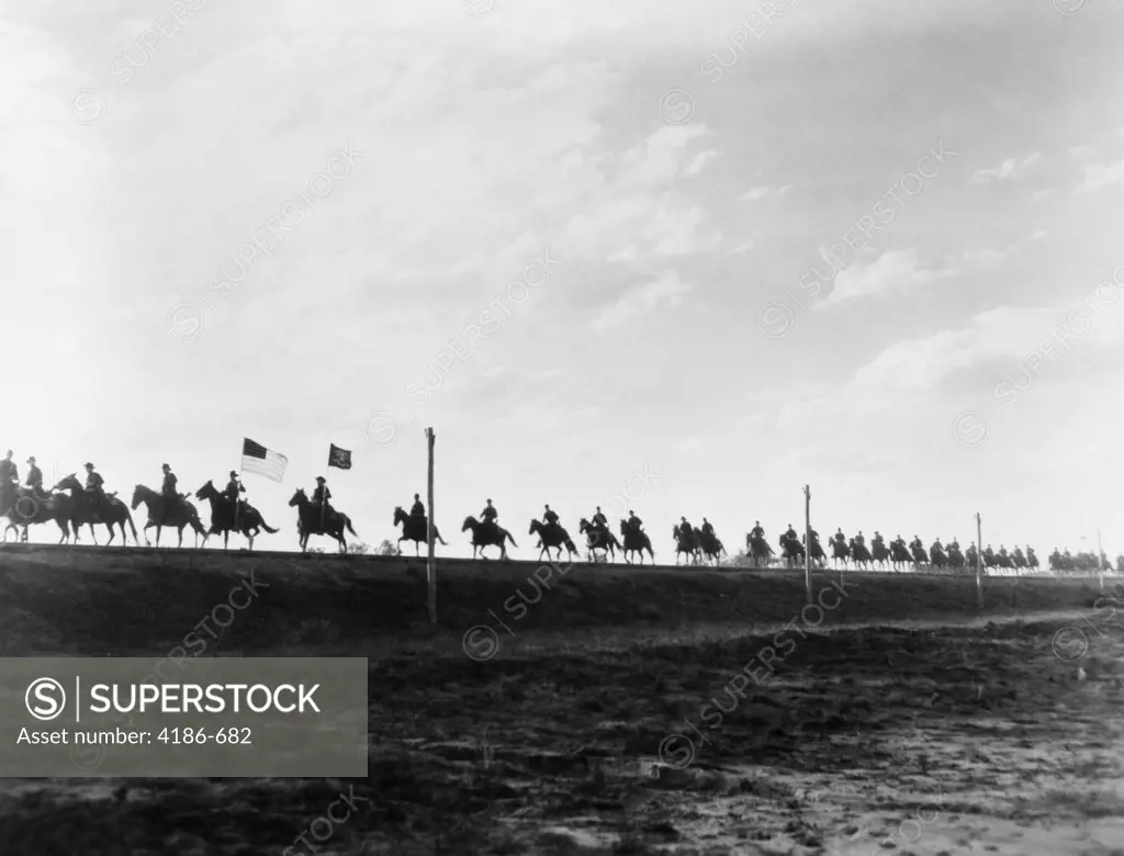 Movie Still Single File Line Of United States Army Cavalry On Horseback In Silhouette On The Horizon