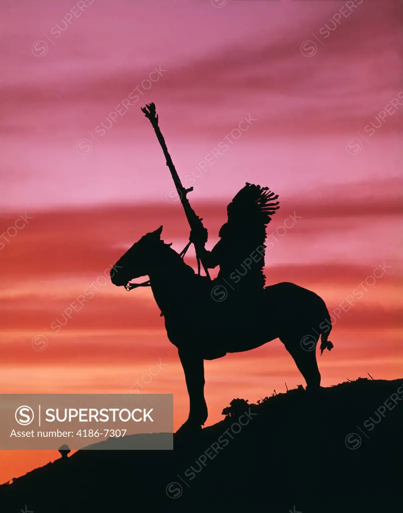 Silhouette American Indian On Horse At Sunset