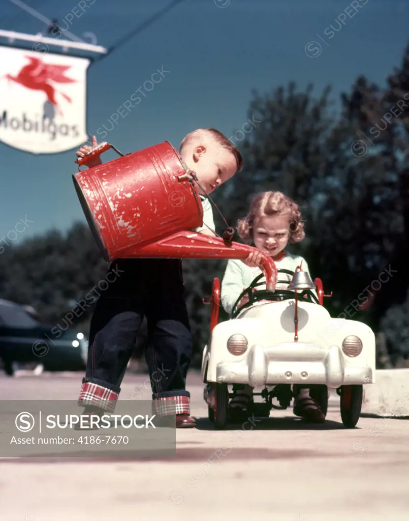 1950S Little Boy Pretending To Service Peddle Toy Car Fire Engine For Little Girl