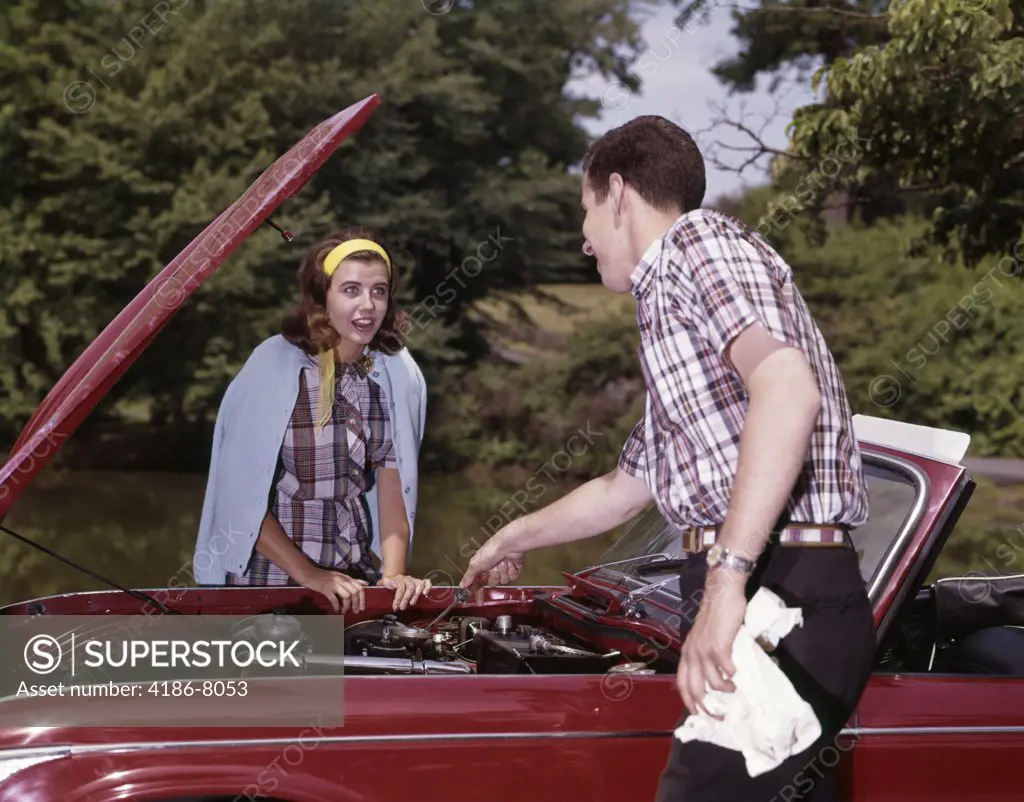 1960S Couple By Car With Hood Up Looking At Motor Outdoor Problem Breakdown