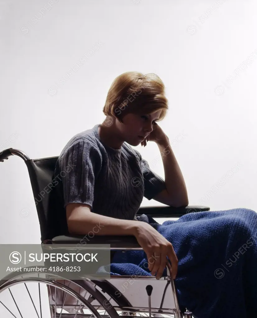 1960S Sad Young Woman Sitting In Wheelchair Blanket Wrapped Around Legs