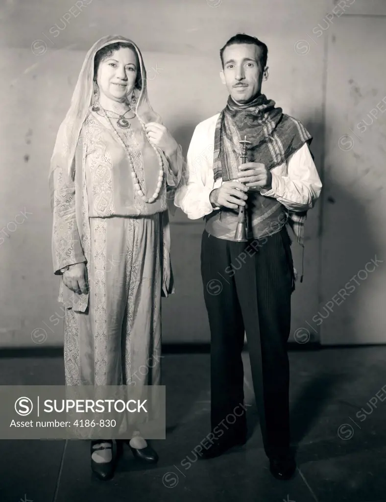 1920S Couple Wearing Turkish Costume Woman Wearing Harem Pants Man With Musical Instrument